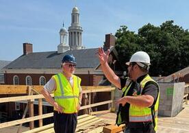 Dean Greg Sterling (left) conferring with construction team on Living Village site